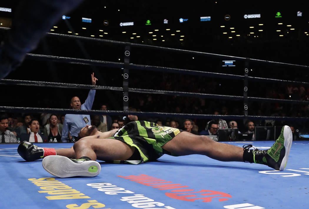 Dominic Breazeale lies on the mat after being knocked down by Deontay Wilder during the WBC hea ...