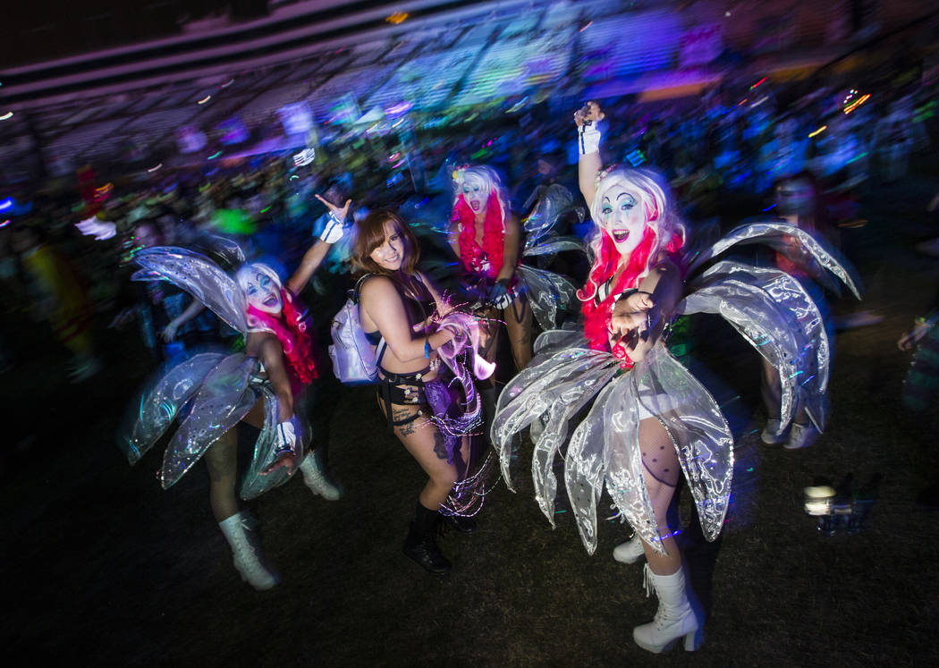 Durann Grijalva, of Las Vegas, dances by the Cosmic Meadow with costumed performers during the ...