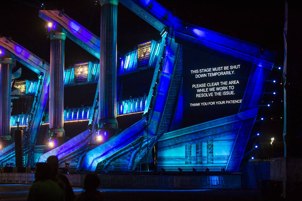 A sign is displayed as the Kinetic Field stage is shut down due to high winds during the second ...