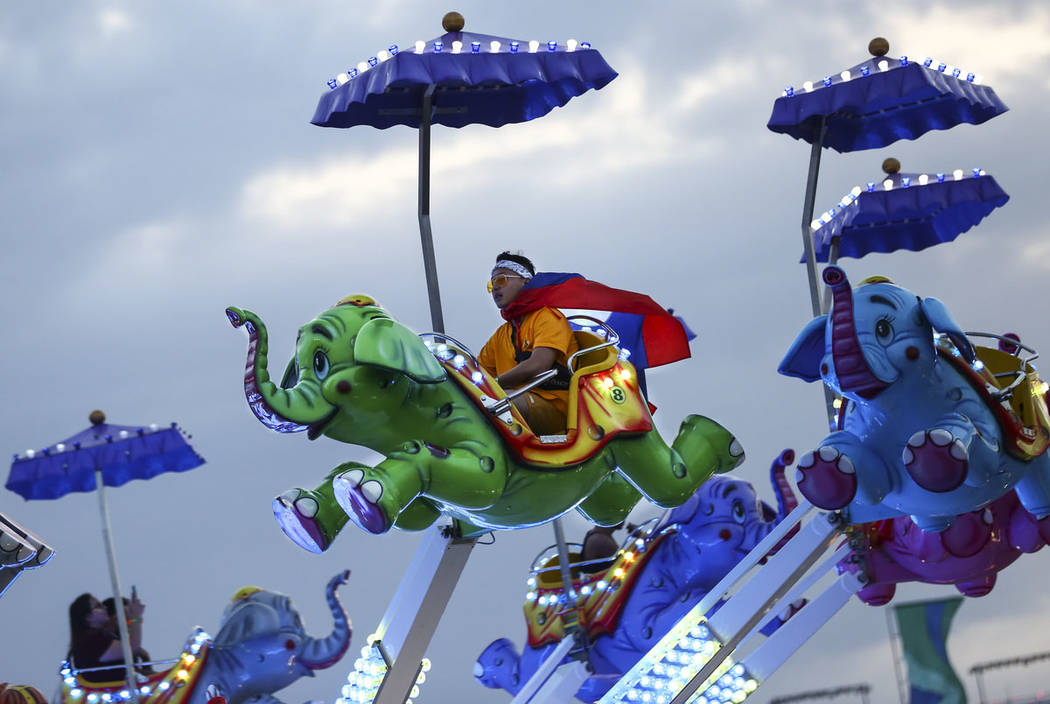 Phouvanh Sengchanh, of Anaheim, Calif., enjoys a carnival ride during the second day of the Ele ...