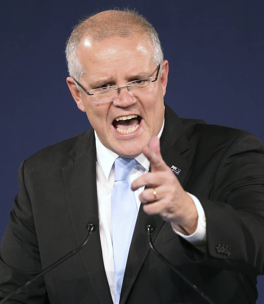 Australian Prime Minister Scott Morrison gestures as he speaks to party supporters after his op ...