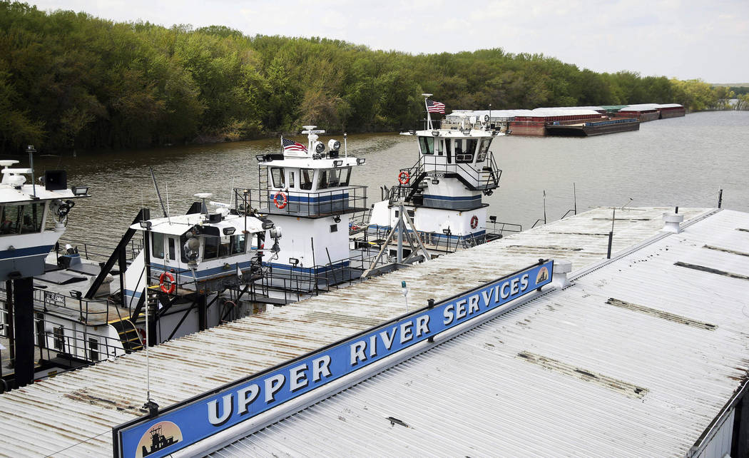 In this Tuesday, May 14, 2019 photo, empty barges, background right, are moored at the Upper Ri ...