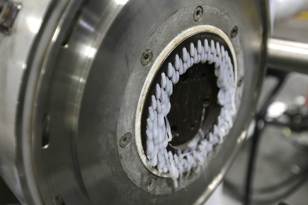 In this May 7, 2019 photo, a machine that produces plastic pellets from plastic film is seen in ...
