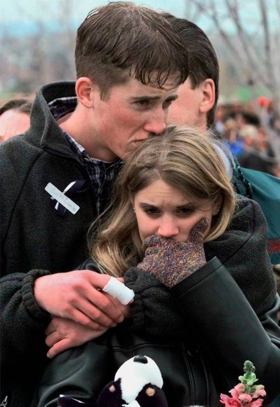 FILE - In this April 25, 1999 file photo, shooting victim Austin Eubanks hugs his girlfriend du ...