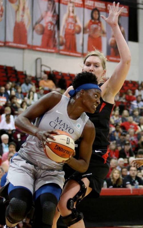 Minnesota Lynx Sylvia Fowles (34) tries to push past Las Vegas Aces Carolyn Swords (8) at a pre ...