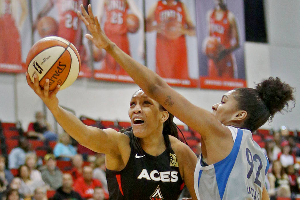 Las Vegas Aces A'ja Wilson (22) tries for a basket against Minnesota Lynx Damiris Dantas (92) a ...