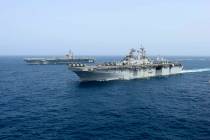 The amphibious assault ship USS Kearsarge sails Friday, May 17, 2019, in front of the USS Abrah ...