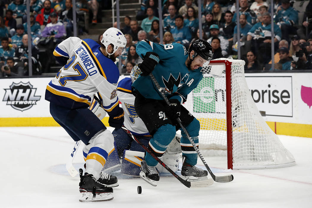 San Jose Sharks' Logan Couture (39) battles for the puck against St. Louis Blues' Alex Pietrang ...