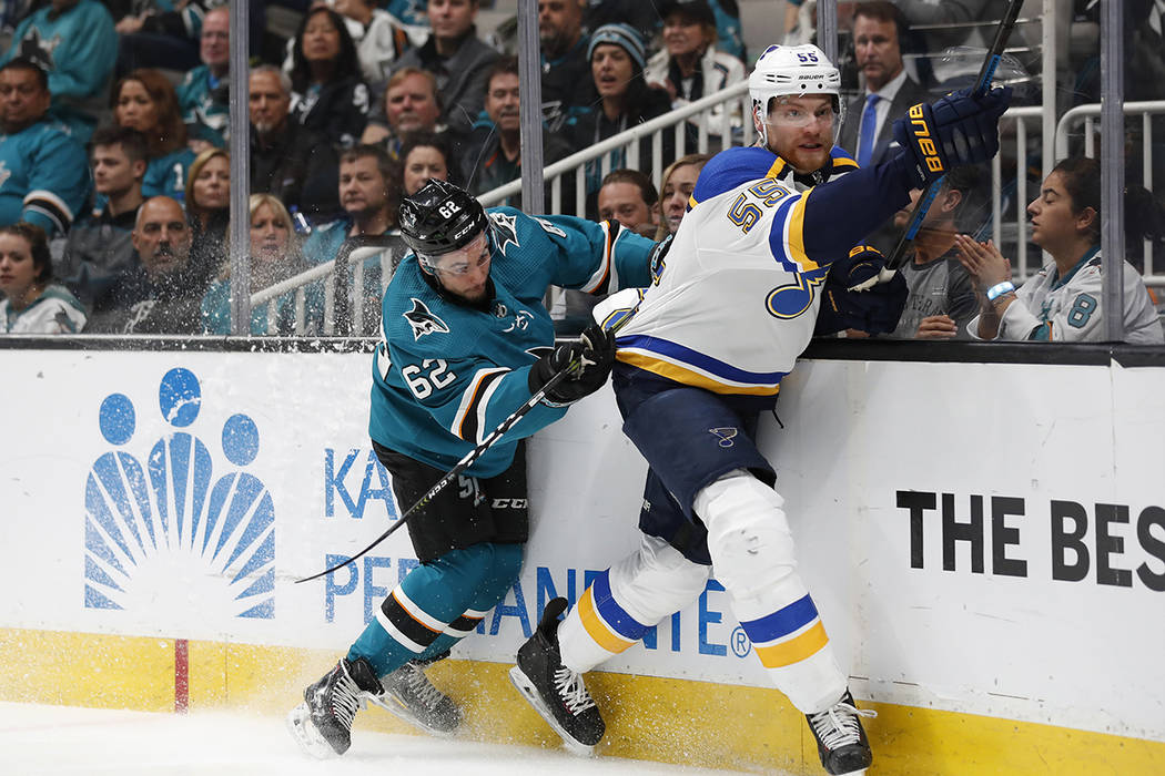 San Jose Sharks' Kevin Labanc (62) battles against the boards with St. Louis Blues' Colton Para ...