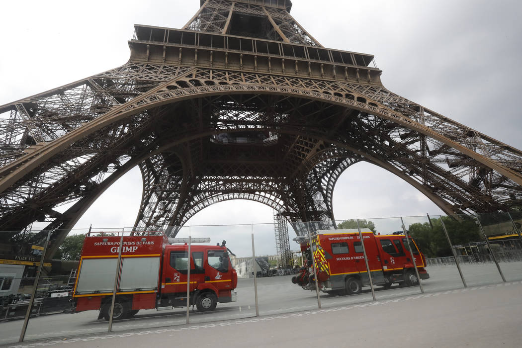 Rescue workers vehicles park just down the Eiffel Tower Monday, May 20, 2019 in Paris. The Eiff ...