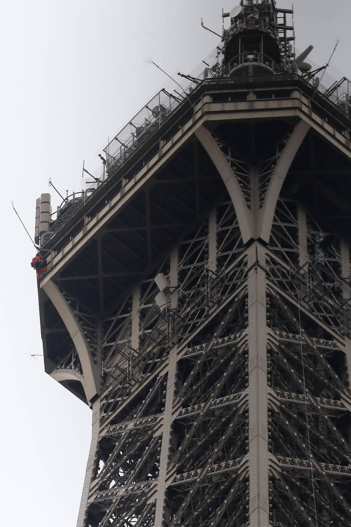 A rescue worker, left in red, climbs the Eiffel Tower Monday, May 20, 2019 in Paris. The Eiffel ...