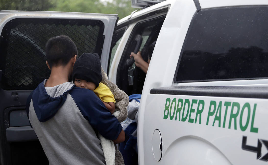 Families who crossed the nearby U.S.-Mexico border near McAllen, Texas, are placed in a Border ...