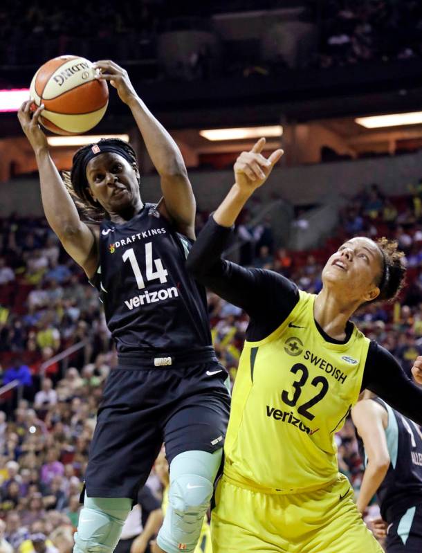 New York Liberty's Sugar Rodgers (14) grabs a rebound next to Seattle Storm's Alysha Clark duri ...