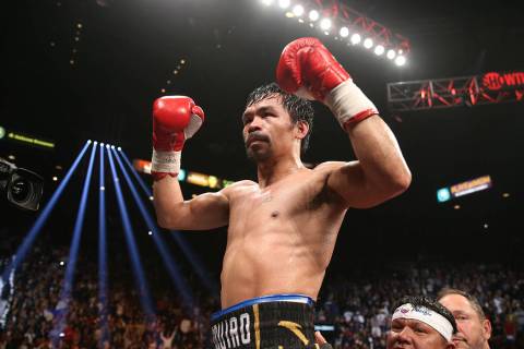 Manny Pacquiao reacts after his fight against Adrien Broner in the WBA Welterweight title bout ...