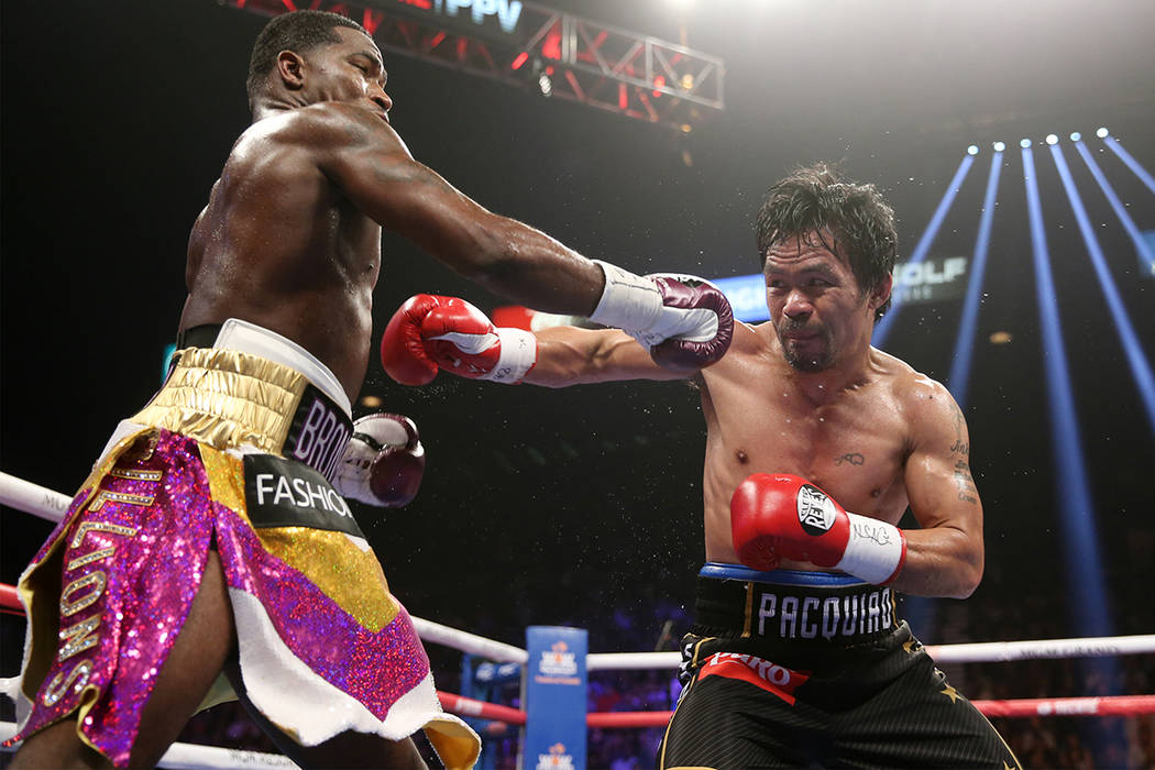 Adrien Broner, left, battles Manny Pacquiao in the WBA Welterweight title bout at the MGM Grand ...