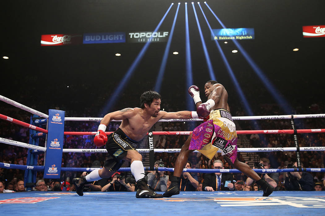 Manny Pacquiao, left, battles Adrien Broner in the WBA Welterweight title bout at the MGM Grand ...
