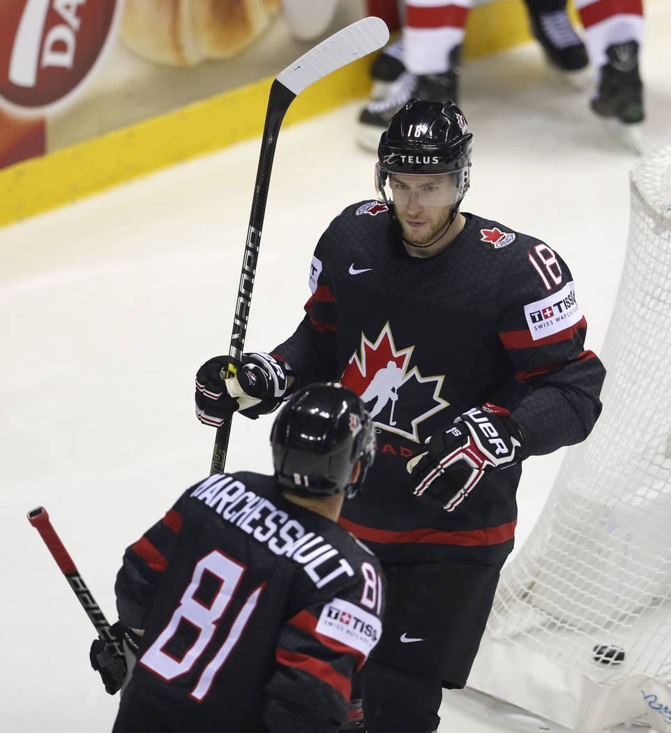 Canada's Pierre-Luc Dubois, right, celebrates with Canada's Jonathan Marchessault, left, after ...
