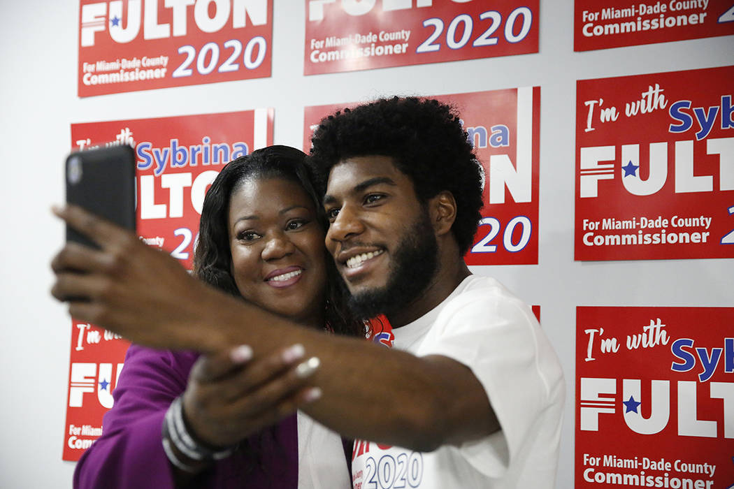 Sybrina Fulton, left, takes a photograph with her son, Jahvaris Fulton, right, after announcing ...