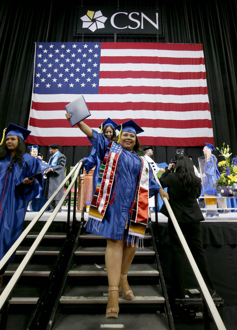 School of Business graduate Polly Flores celebrates after walking across the stage during Colle ...