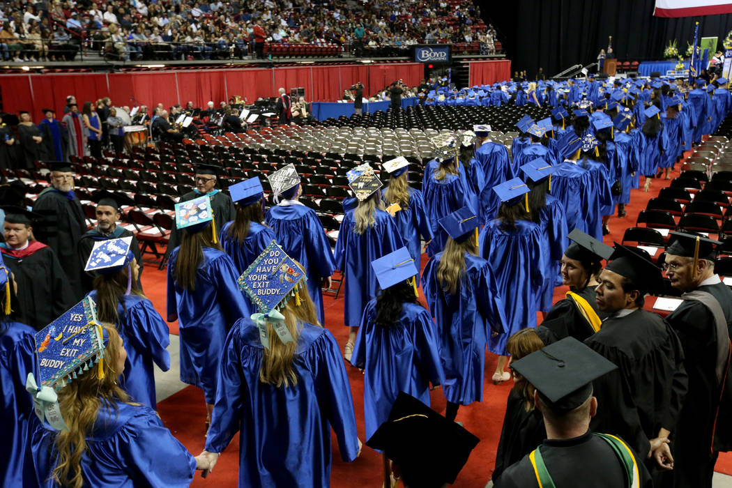 Graduates walk in the processional during College of Southern Nevada commencement ceremony at T ...