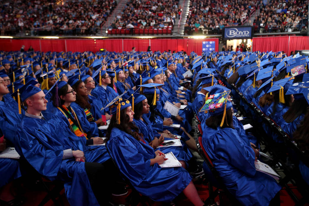 Graduates listen to speakers during College of Southern Nevada commencement ceremony at Thomas ...