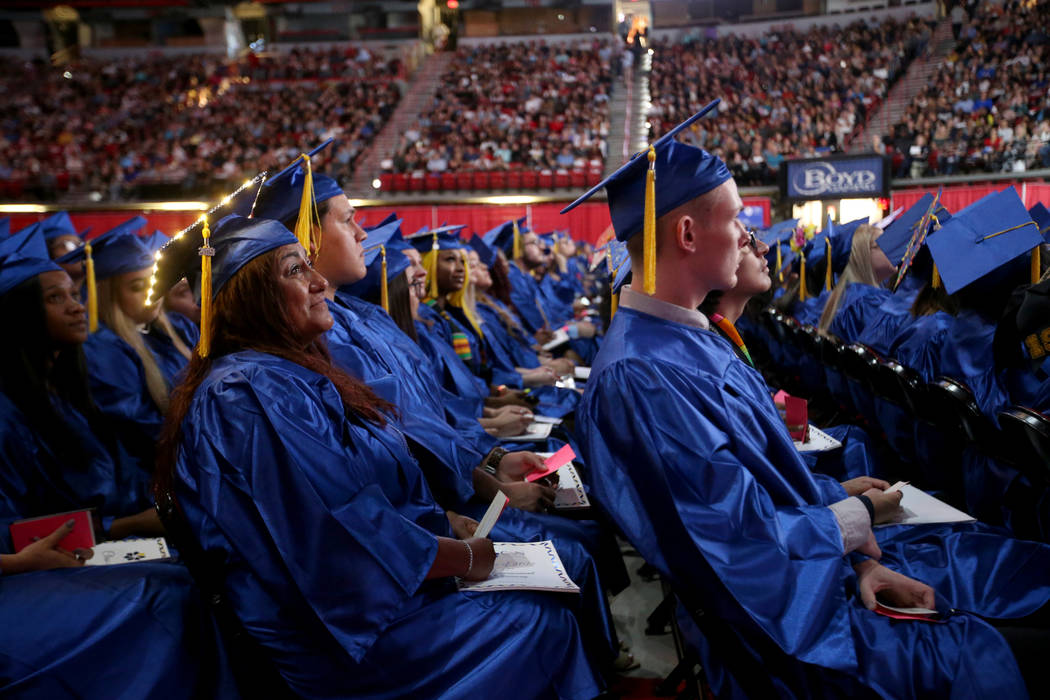 Graduates, including Ramona Schafer, left, listen to speakers during College of Southern Nevada ...