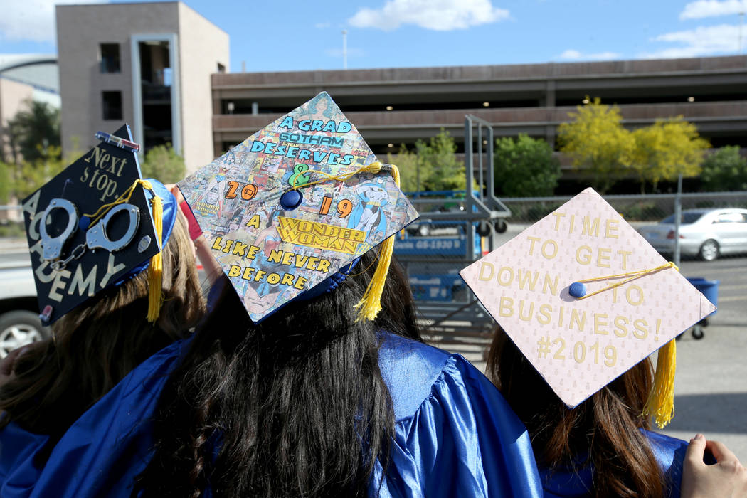 Graduates, from left, Jennifer Labelle, Amanda Rodriguez and Klarisse Policarpio don personaliz ...