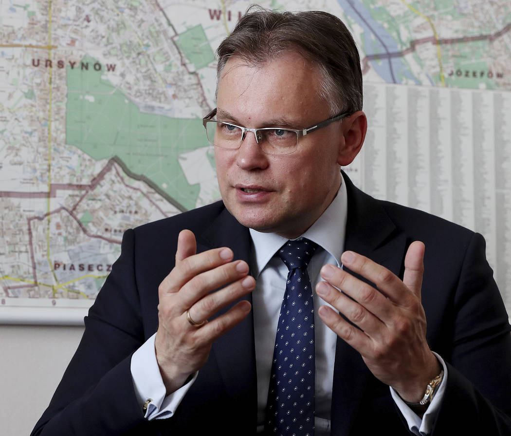 Poland's ruling party lawmaker Arkadiusz Mularczyk talks to The Associated Press in the parliam ...