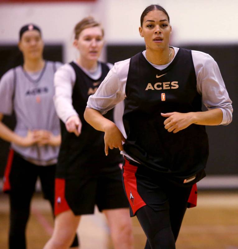 Aces center Liz Cambage, right, with JiSu Park, left, and forward Carolyn Swords during practic ...