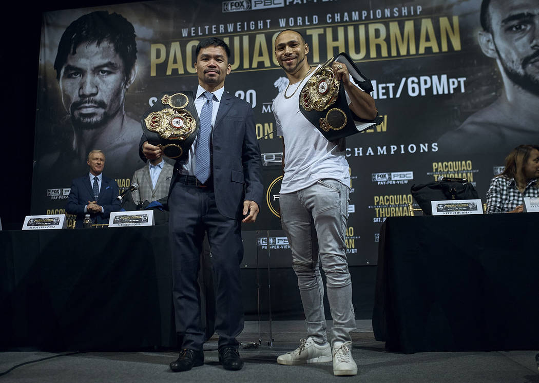 Manny Pacquiao, left, and Keith Thurman pose for a picture during a news conference on Tuesday ...