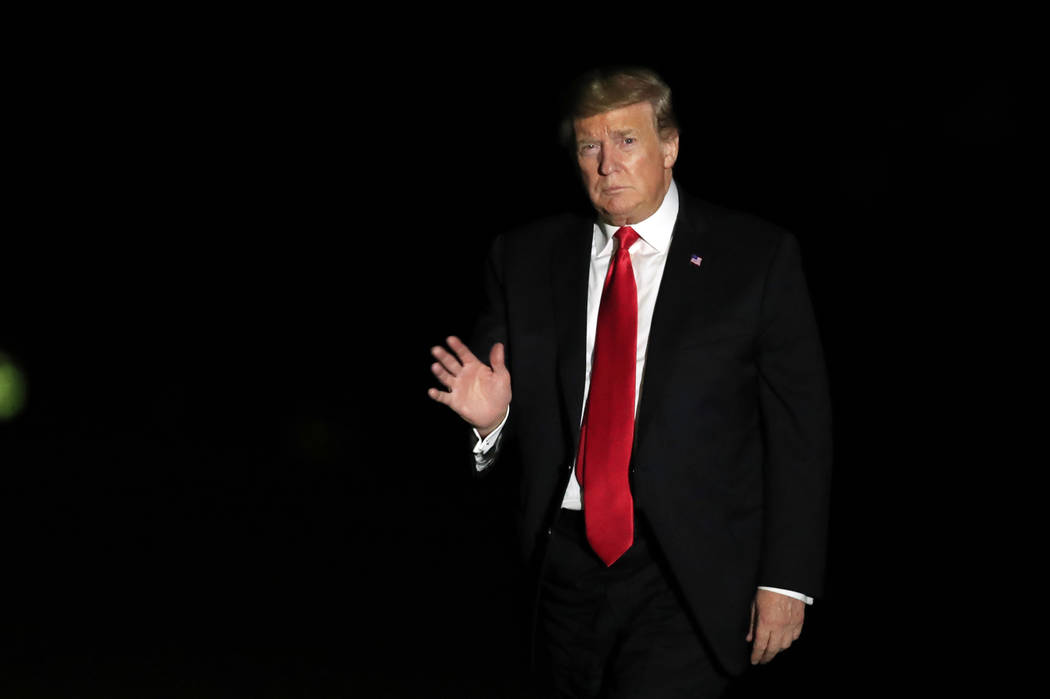 President Donald Trump waves upon arrival at the White House in Washington, from a campaign ral ...