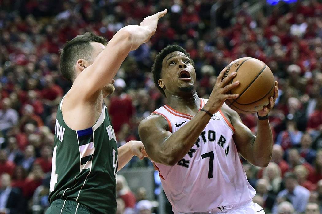 Toronto Raptors guard Kyle Lowry (7) drives for the basket as Milwaukee Bucks guard Pat Connaug ...