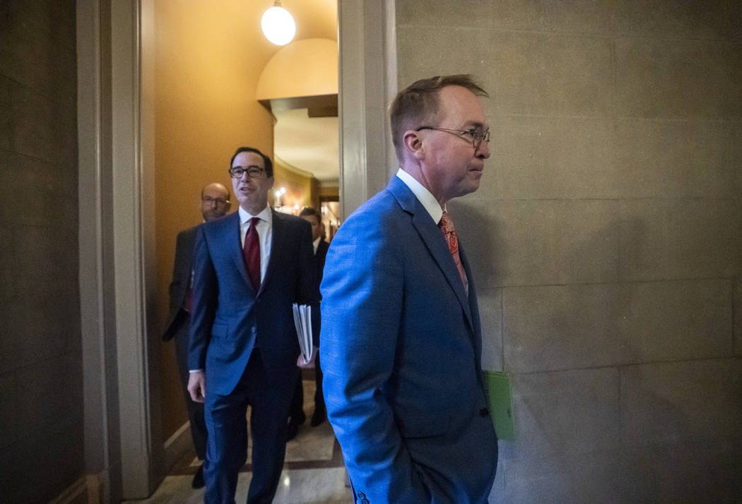 President Donald Trump's acting Chief of Staff Mick Mulvaney, center, and Treasury Secretary St ...