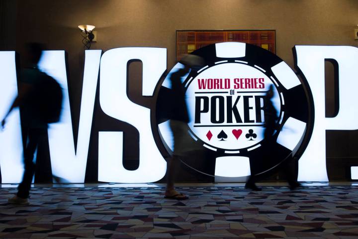 People walk past a World Series of Poker sign day five of the competition at the Rio Convention ...