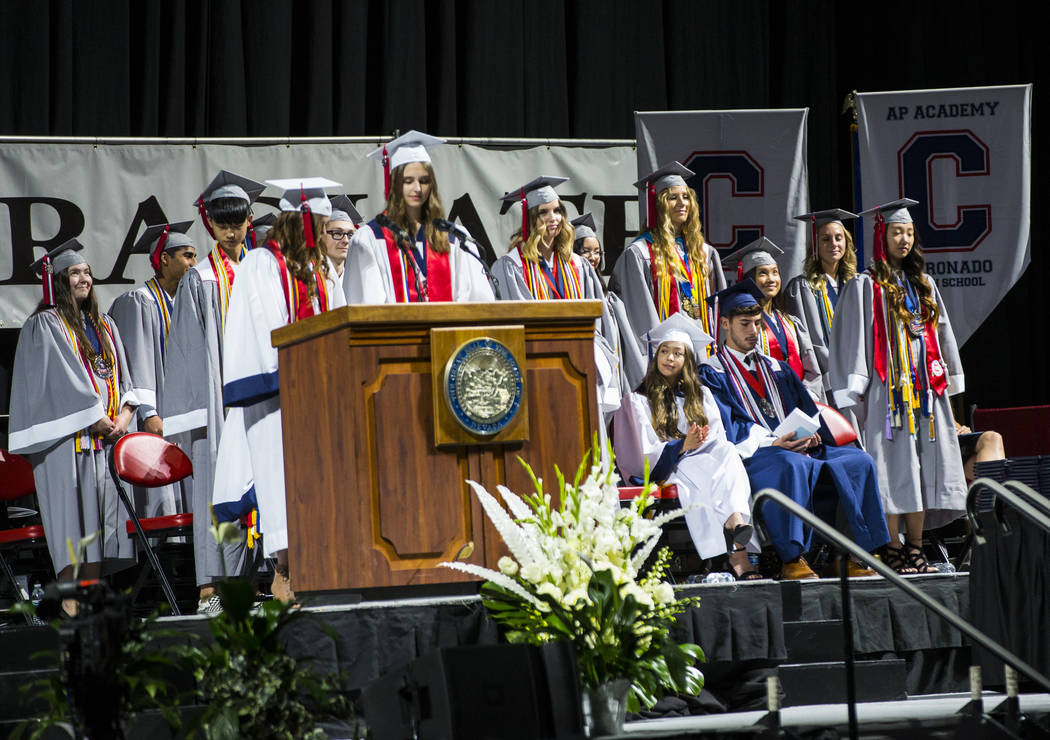 Graduating Coronado High School valedictorians, wearing gray robes, stand to be recognized duri ...