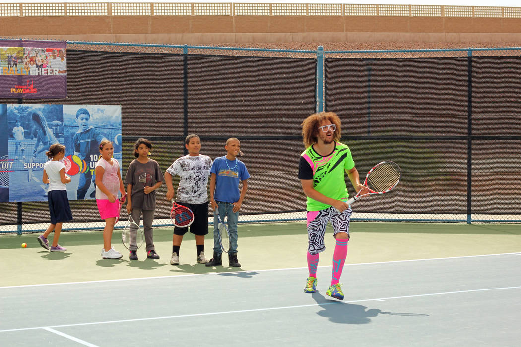 Pop star and tennis buff Redfoo works with youth players at the 2012 Party Rock Open at Darling ...