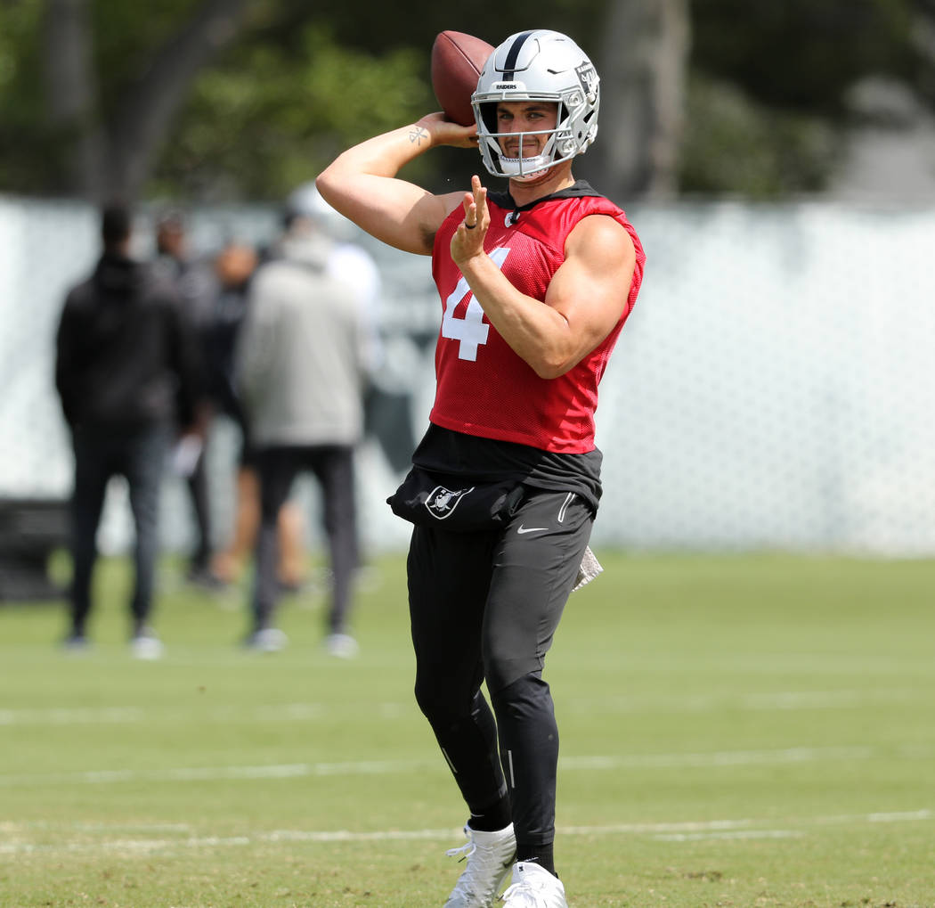 Oakland Raiders quarterback Derek Carr prepares to throw the football during an offseason train ...