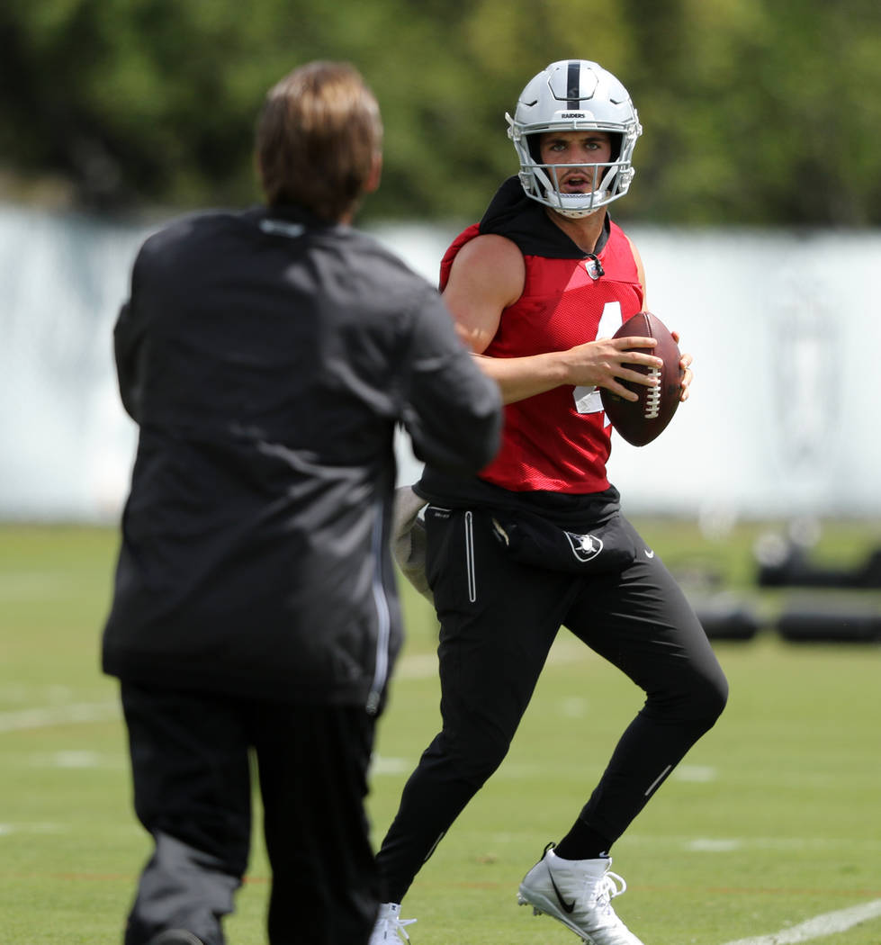 Oakland Raiders quarterback Derek Carr prepares to throw the football during an offseason train ...