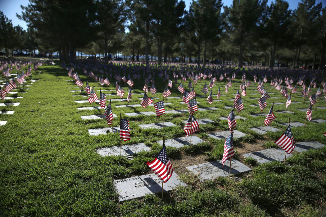 Flags fly above grave sites during the annual “Flag-In” event at the Southern Nev ...