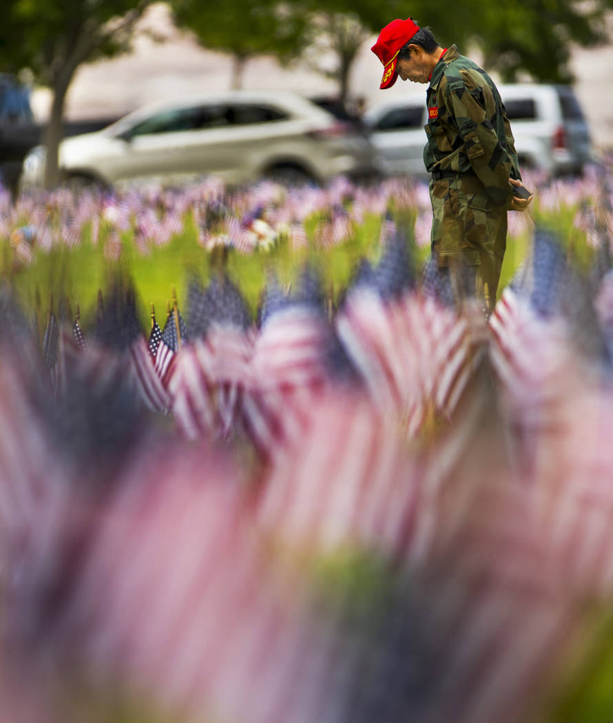 Moosun Lee stops to pay tribute during Memorial Day before a ceremony at the Southern Nevada Ve ...
