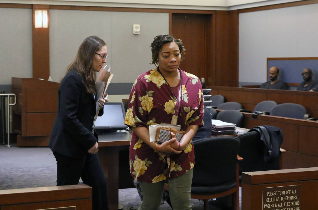 Cadesha Bishop, 25, right, accused of shoving a 74-year-old man off a bus, leaves the courtroom ...