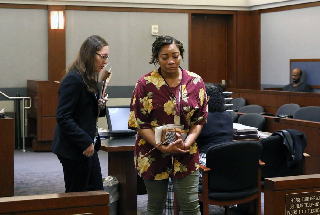 Cadesha Bishop, 25, right, accused of shoving a 74-year-old man off a bus, leaves the courtroom ...