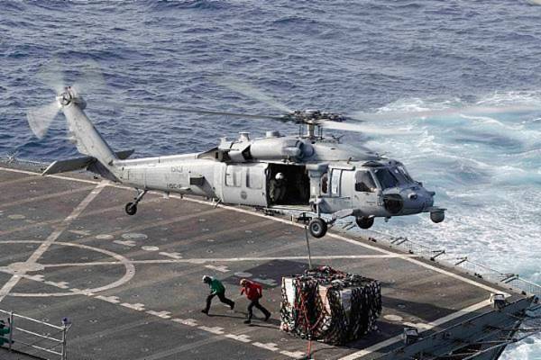 In a Sunday, May 19, 2019 photo, an MH-60S Sea Hawk helicopter transports cargo from the fast c ...