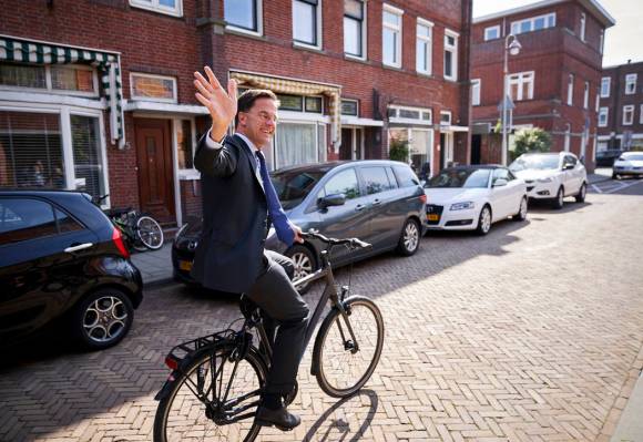 Netherlands Prime Minister Mark Rutte leaves on his bike after voting in the European elections ...