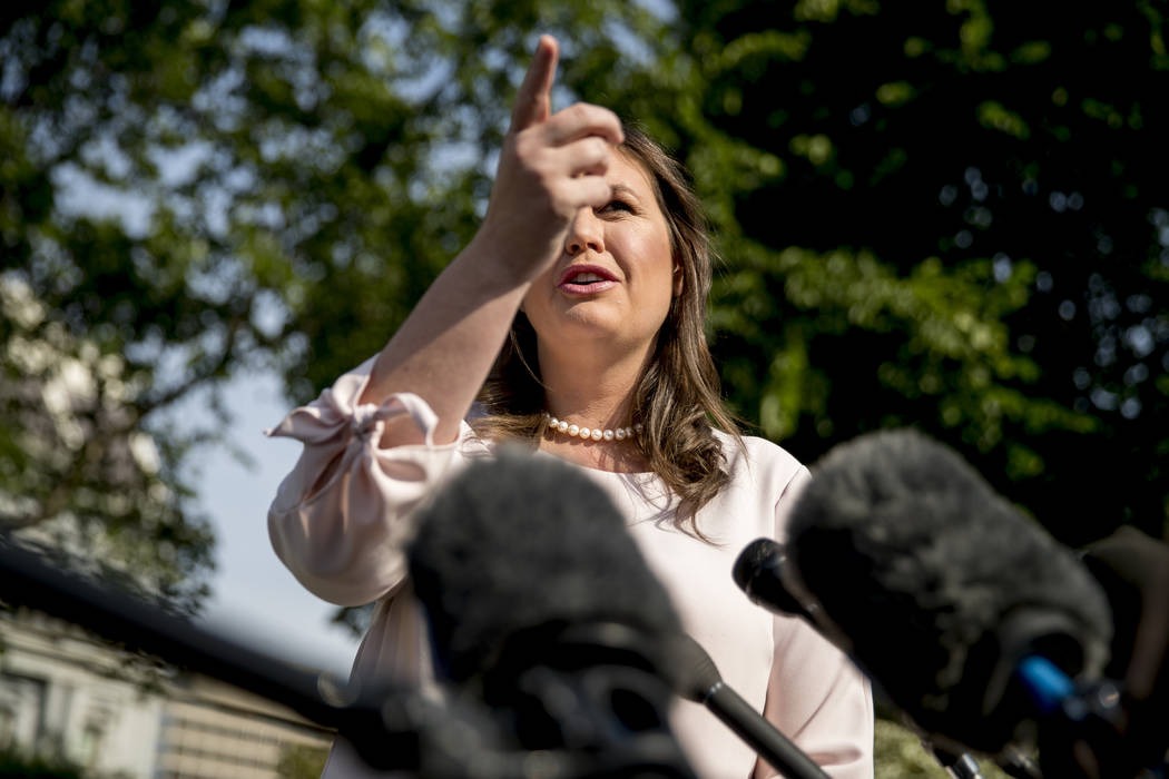 White House press secretary Sarah Huckabee Sanders takes a question from a reporter on the Nort ...