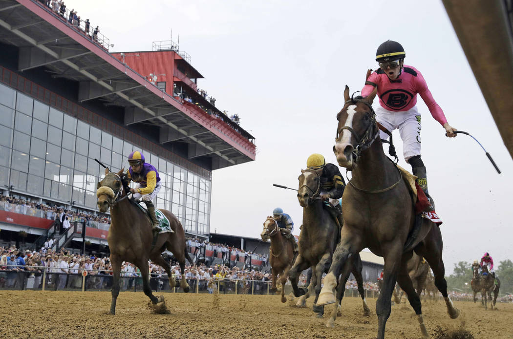 Jockey Tyler Gaffalione, right, reacts aboard War of Will, as they crosses the finish line firs ...