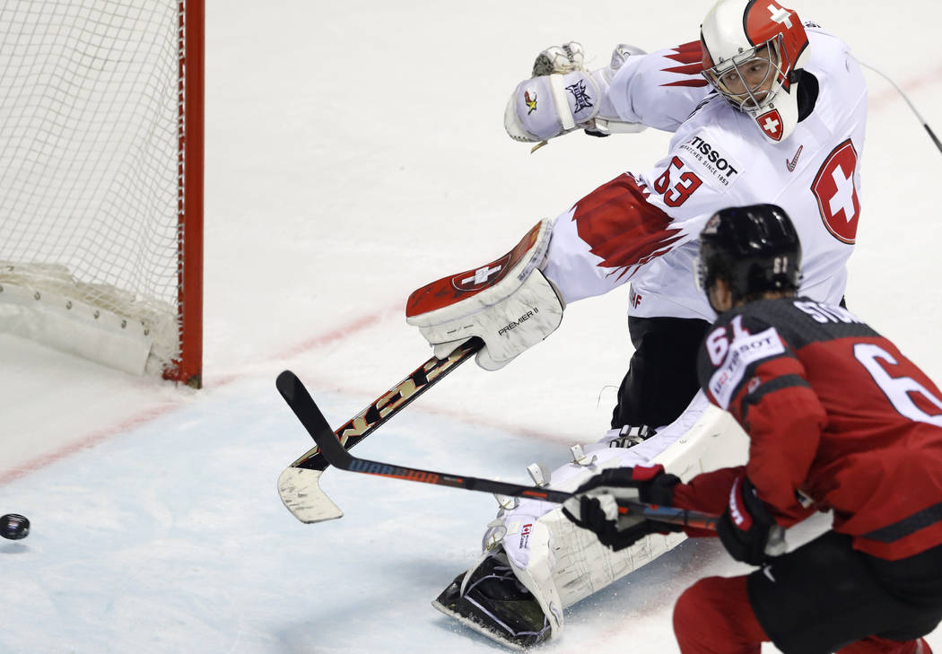 Canada's Mark Stone, right, scores his side's third goal past Switzerland's goalkeeper Leonardo ...