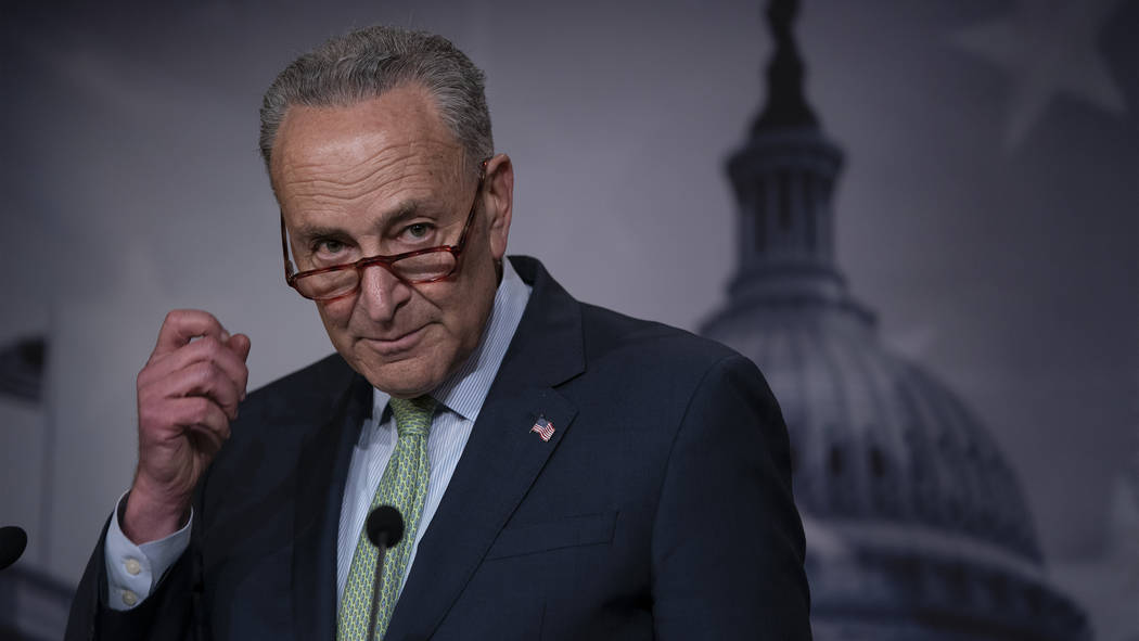 Senate Minority Leader Chuck Schumer, D-N.Y., talks to reporters just after the Senate passed a ...