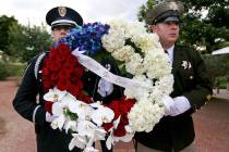 Officers hold flowers for the Southern Nevada Law Enforcement Officers memorial service at Poli ...