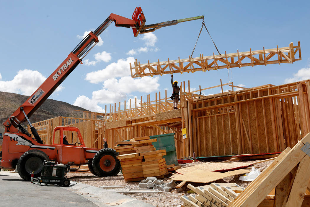 Workers construct houses near the corner of Mesa Park Drive and Hualapai Way in the Summerlin a ...